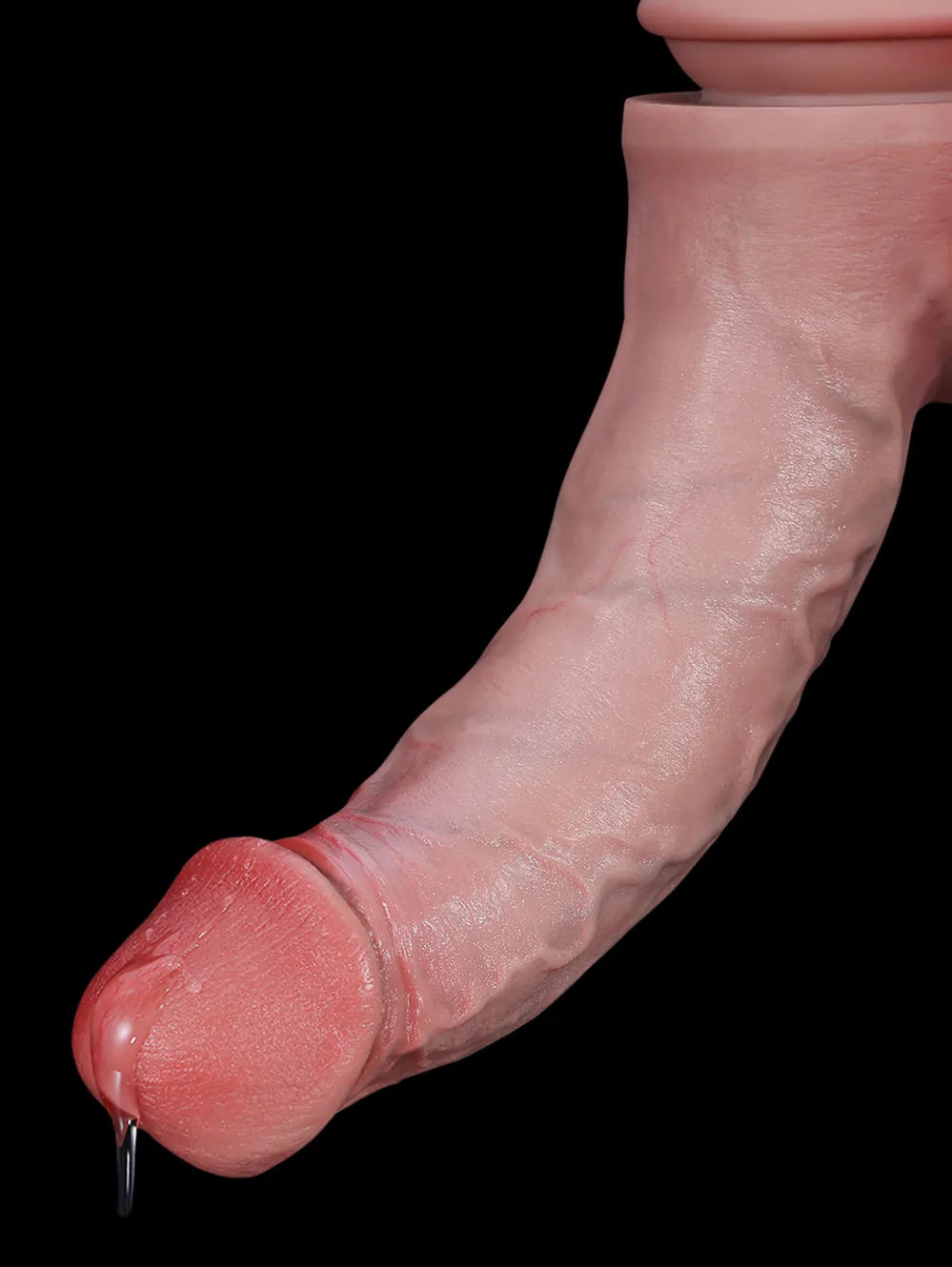 Close-up of the curved tip of the large realistic dildo on a black background