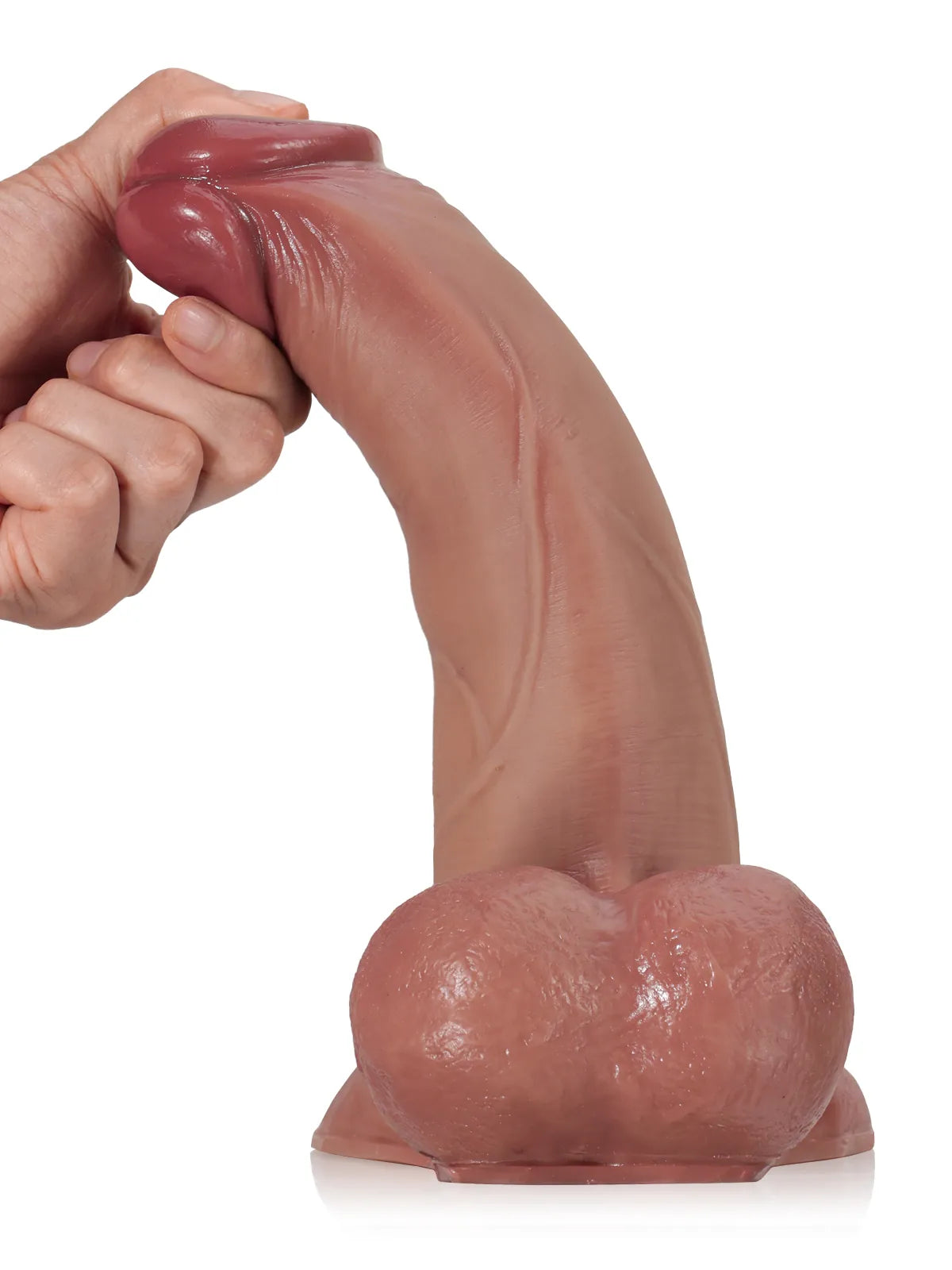 Hand bending the brown sliding skin dildo with moving balls forward